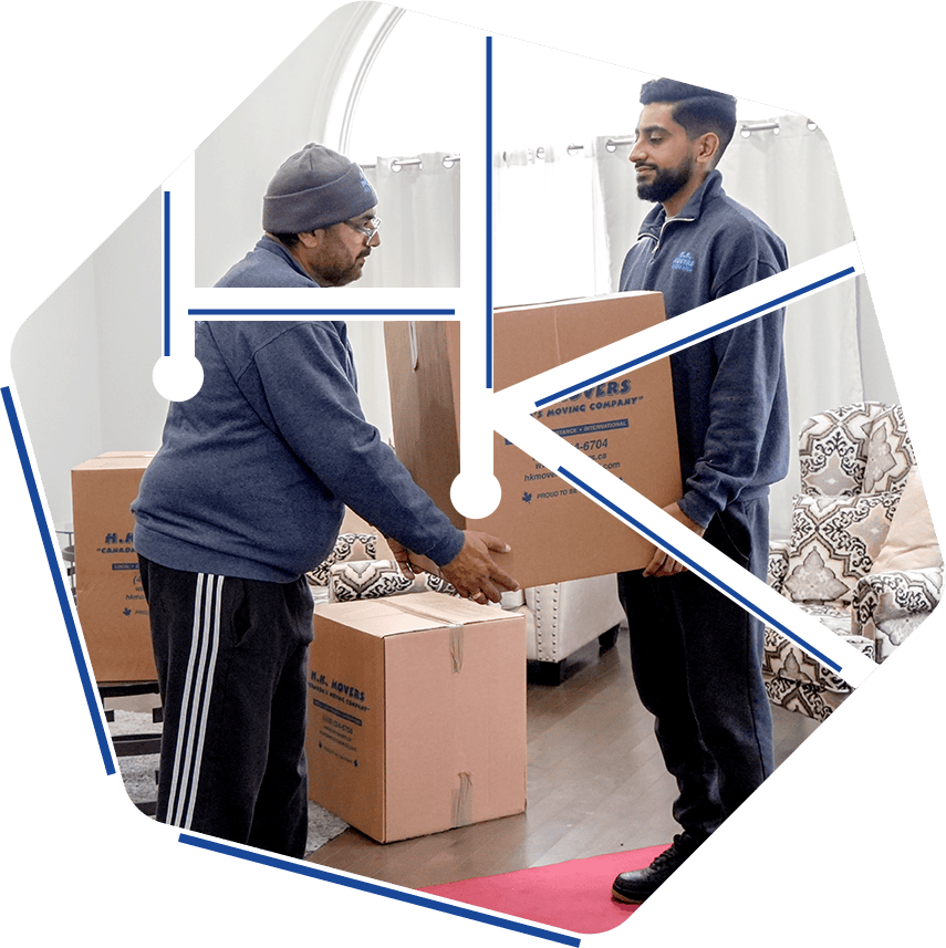 Professional movers carefully handling boxes during residential moving service by HK Movers in Toronto.