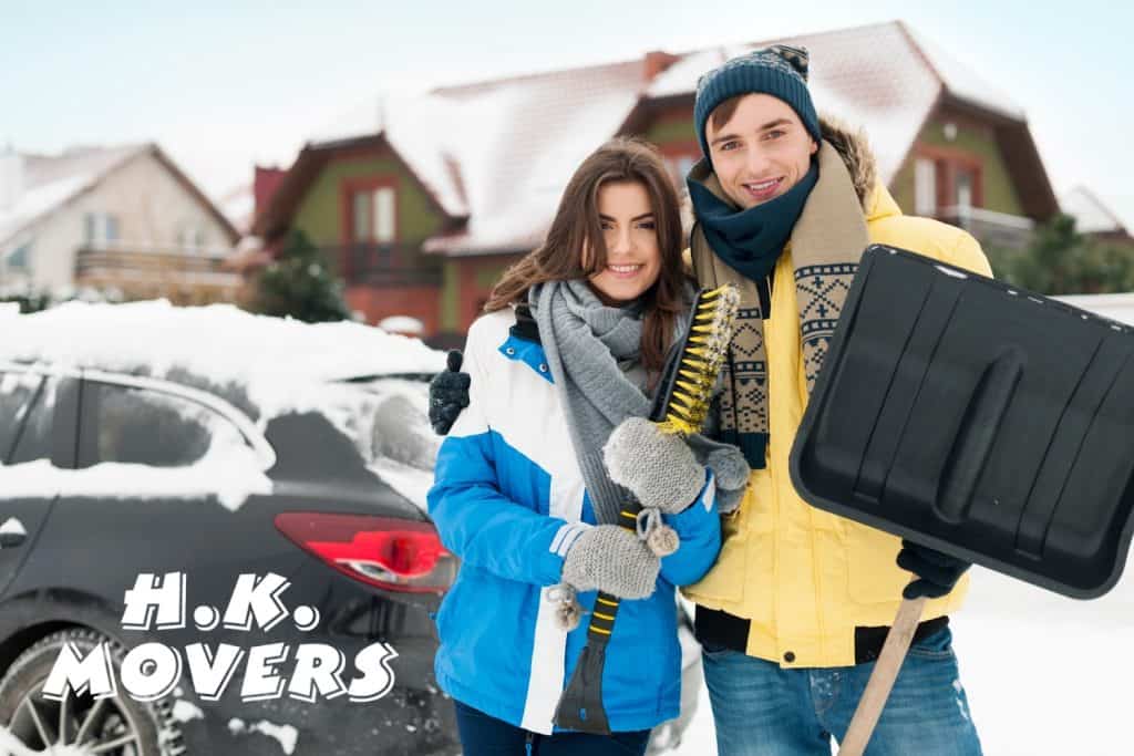 Snowy residential moving day with professional movers from HK Movers, showcasing efficient packing and moving services in winter conditions.