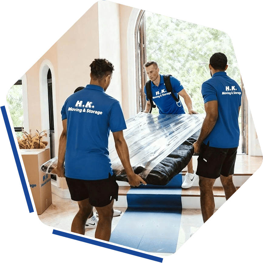 H.K. Moving & Storage professional movers loading furniture into a home for safe relocation and premium moving services.