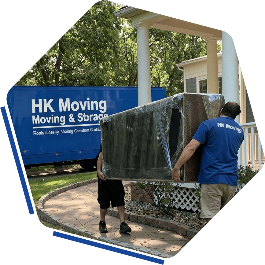 Moving company packing furniture onto truck in front of house, professional movers, HK Movers, house moving, local and long-distance moving services, residential moving professionals.