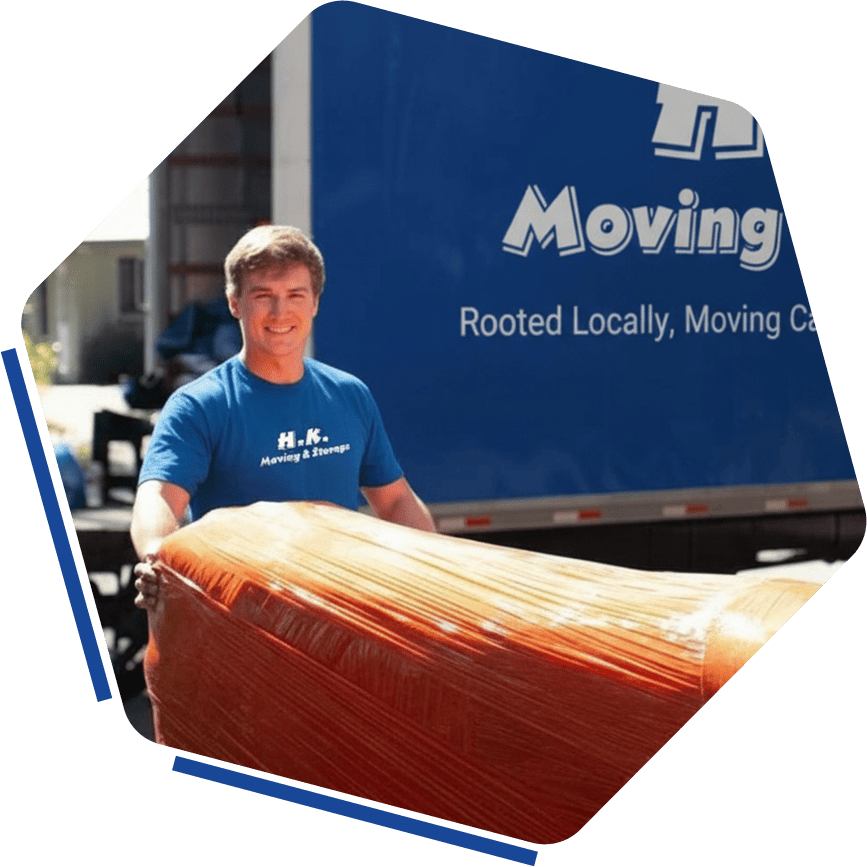 Wrapped furniture being moved by professional movers outside HK Movers truck in Vancouver.