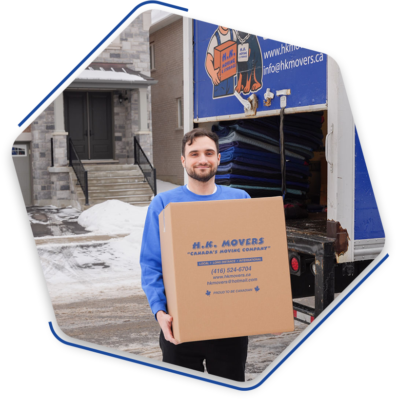 Mover carrying box near moving truck