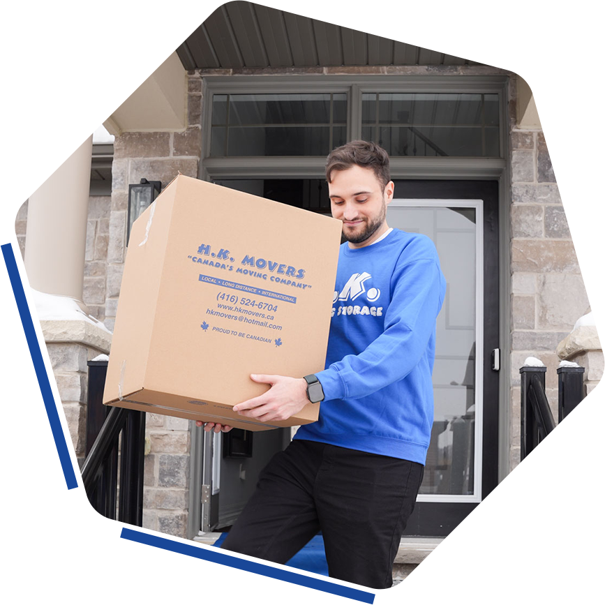 Mover carrying box outside a house