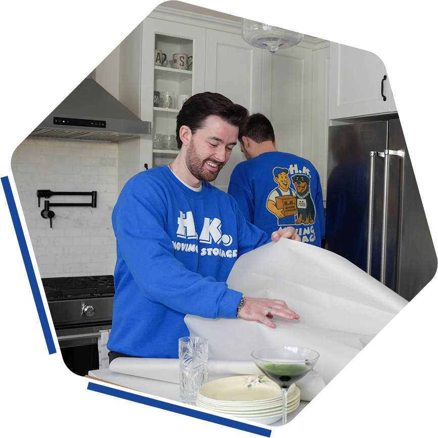 Movers packing kitchen items carefully