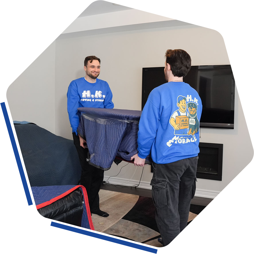 Movers carrying furniture in living room
