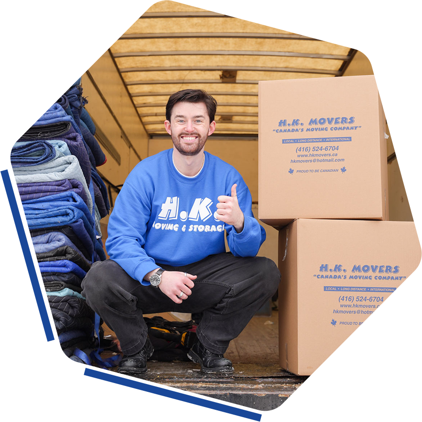 Mover smiling beside packed boxes in truck