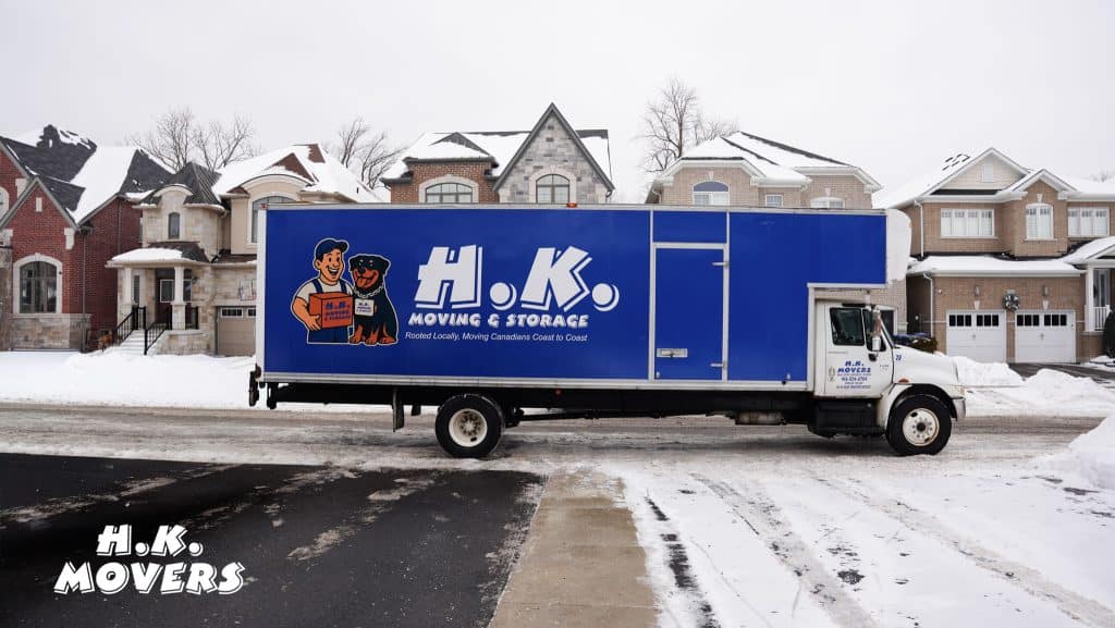 H.K. Movers truck parked on snowy street