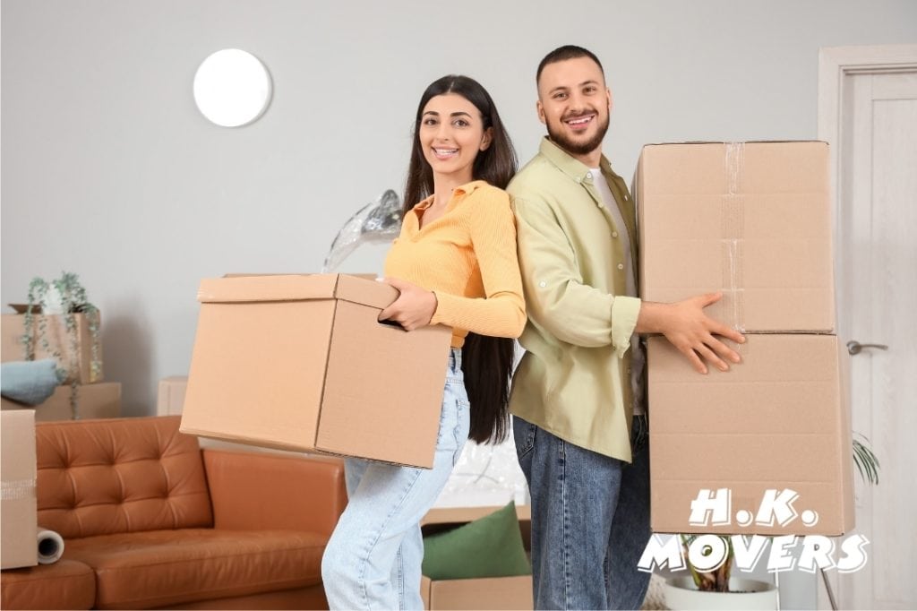 Professional movers from HK Movers carrying boxes for a local move.